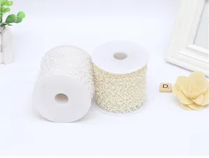 Detailed view of two spools with 4mm white and ivory ABS faux pearl strings