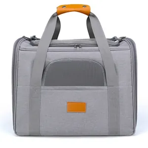 Detail view of a grey foldable pet carrier with mesh window and leather handle.