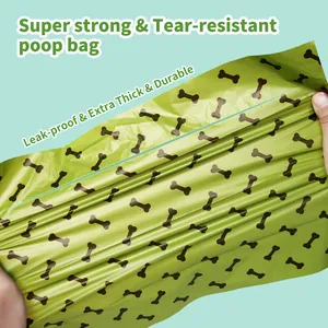 Close-up showing the stretch and tear resistance of the green bone pattern poop bag