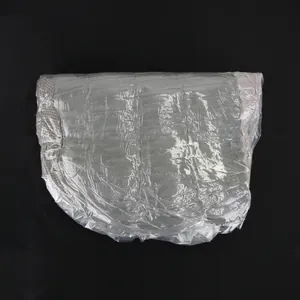 Warm gray quilted slipper-shaped cat bed nest shown in protective plastic packaging wrap