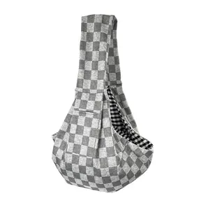 Detail view of a grey checkered pet sling carrier designed for small cats and dogs