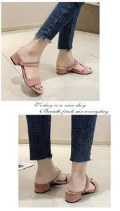 Detalle de las elegantes sandalias de ante rosa con tacón bloque bajo y tiras.