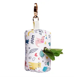 Close-up of the cartoon patterned pet waste bag dispenser with a green bag protruding.