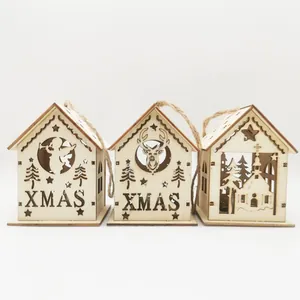 Set of three detailed laser-cut wooden Christmas house ornaments featuring XMAS text