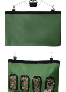Close-up detail of green hanging hay bag with four feeding holes for rabbits and small pets