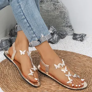 Stijlvolle platte dames sandalen met vlinderaccenten van strass en zachte zolen.