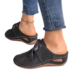 Stylish women's grey hollow-out wedge mules with lace-up design for summer comfort.