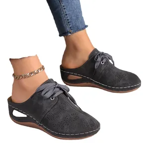 Elegant dark grey closed-toe mule sandals for women with lace-up detail and wedge heel