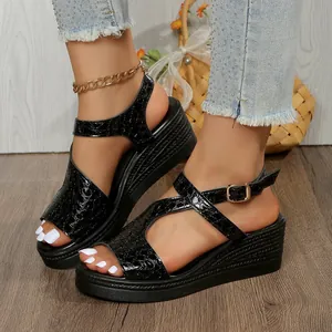 Vue détaillée des sandales à talons compensés noires à motif crocodile pour femme