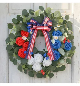 Detailed view of Fourth of July wreath with red white blue roses and flag ribbon