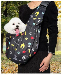Detail view of an adjustable black pet sling carrier with cute puppy patterns.