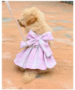 Rear view of a dog wearing a pink plaid JK-style harness dress with a large bow