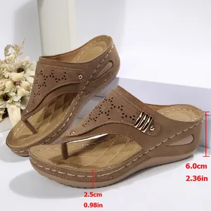 Detail view of brown thong wedge slippers with height measurements in cm and inches