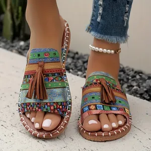 Detailed view of colorful Bohemian flat sandals featuring stylish brown tassels and patterns