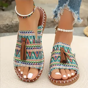 Bohemian flat sandals with colorful geometric patterns and brown tassels for beachwear