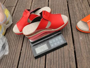 Red wedge peep-toe sandals for women shown on a digital scale weighing 396 grams