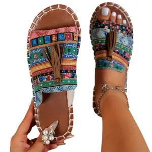 Stylish Bohemian flat sandals with colorful ethnic print and brown tassels for beach