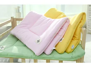 Close-up of pastel waffle-weave pet mats in pink, yellow, and green colors.