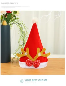 Detailed view of red velvet Christmas hat featuring glittery antlers and a polka dot bow