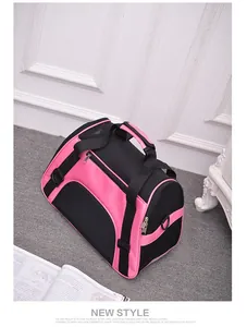 Detailed view of pink breathable mesh pet carrier bag for travel with handle.