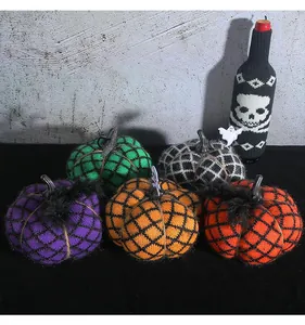Decorative handmade knitted pumpkins in various colors for Halloween party scenes