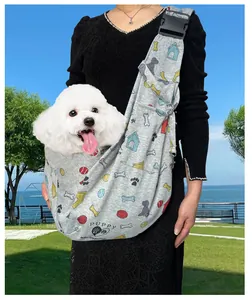 Detail of portable pet sling carrier with cute puppy patterns and adjustable buckle.