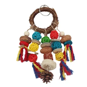 Colorful parrot chew toy featuring rattan ring, wicker balls, and natural pinecone