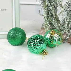 Set of three green Christmas baubles with glitter and textured finishes for holiday decor