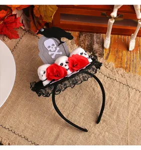 Detail view of a Halloween tombstone headband with red roses and a black crow.