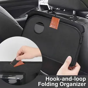 Detail view of foldable car seat back organizer showing the brown leather velcro strap