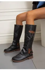 Detailaufnahme schwarzer Kniehoher Martin-Stiefel mit braunen Schnallenriemen und Schnürung
