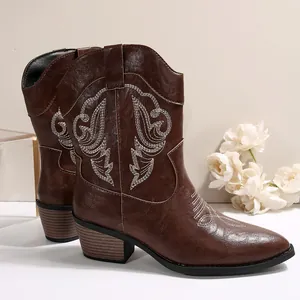 Vintage brown Western cowboy boots with detailed white embroidery and mid-thick heels