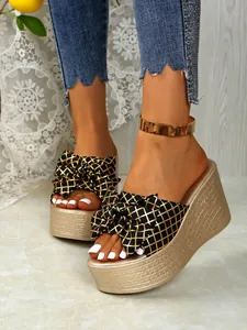 High platform wedge slides with gold grid bow detail and chunky textured sole