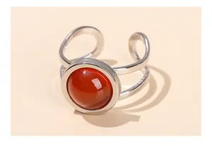 Detailed view of a silver titanium steel open ring with a large round red agate stone