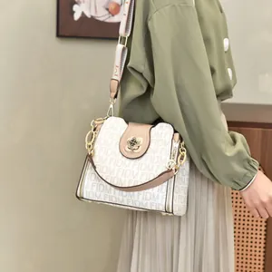 Stylish monogram print bucket bag for women with floral clasp and adjustable strap