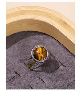 High-quality close-up of a titanium steel open ring featuring a round brown tiger eye stone