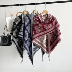Close-up of textured paisley patterns on faux cashmere shawls in black blue and red shades