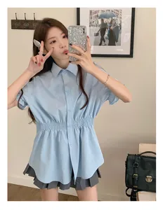 Detail of light blue short-sleeved shirt featuring a flattering elasticated cinched waist
