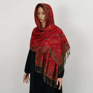Nahaufnahme des roten Schals mit Paisley-Muster, eleganten Fransen und Ethno-Design.