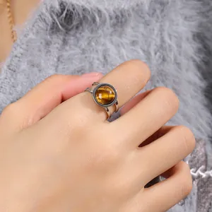 Women's adjustable silver titanium steel ring with a round polished tiger eye stone inlay