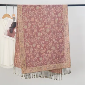 Detailansicht eines lila Schals mit Paisley-Jacquard-Muster und feinen Fransen am Saum.
