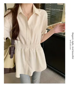 Detailed view of cream short-sleeve blouse featuring elegant smocked waist design