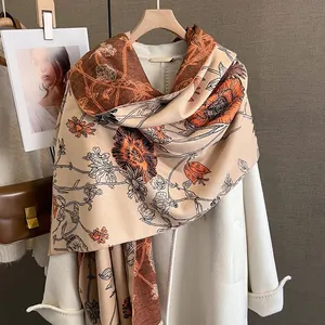 Macro view of double-sided cashmere-like shawl featuring elegant ink floral patterns