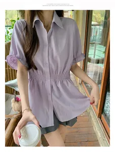 Detail of lavender short-sleeved shirt featuring a cinched waist and button-down front.