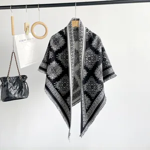 Close-up of black and white paisley pattern faux cashmere shawl with fringe