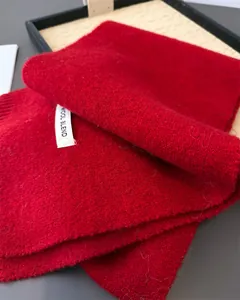 Nahaufnahme eines roten Strickschals aus Wollmischung mit weicher Textur