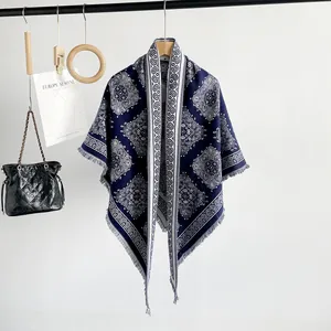 Close-up of blue and white paisley shawl hanging on a wooden hanger with accessories
