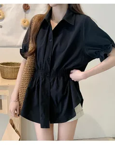 Close-up showing the elasticated waist and pleated sleeve details of this black shirt
