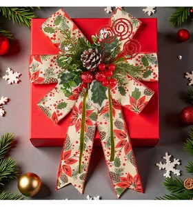 Close-up of a festive Christmas bow with pinecones and berries on a red gift box.