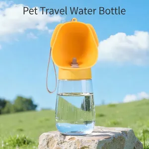 Portable yellow pet water bottle for dogs on a rock in outdoor nature